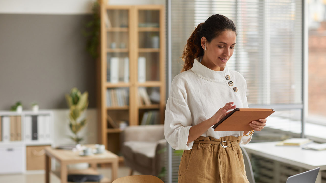 Woman using tablet in home office